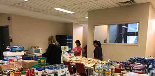 Volunteers organize food resources.