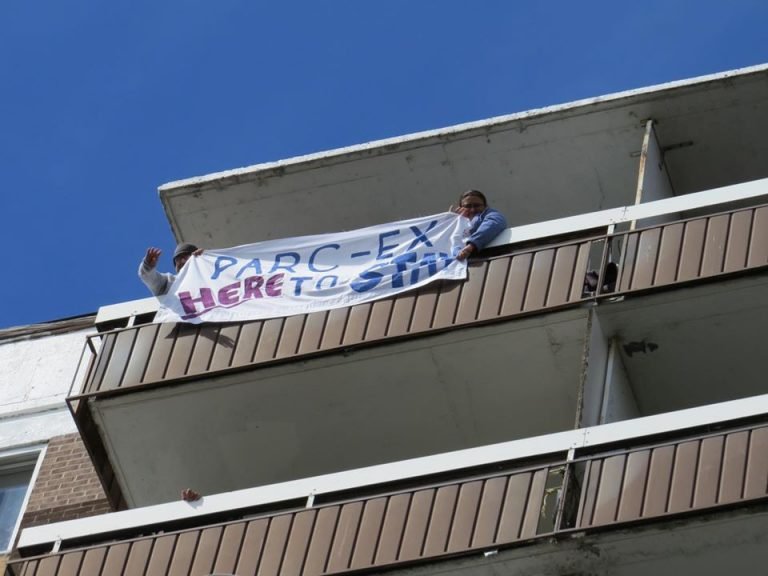 Residents hold up signs saying no to evictions in Park Extension during the caravan protest held on June 11. Photo: CAPE